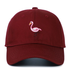 Close-up of pink flamingo embroidery on dark burgundy cotton baseball cap front