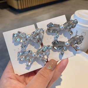 Sparkly crystal bow hair clips with pearls and rhinestones in clear and grey tones