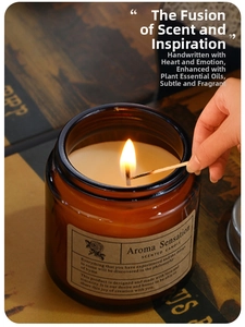 Close-up of a lit scented candle in amber glass jar with vintage label on a rustic map