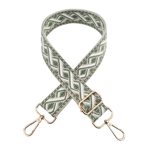 Detail of adjustable green and beige jacquard woven strap with golden metal hardware