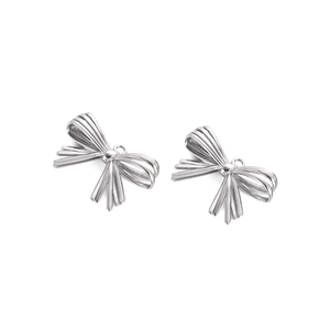 Detail of silver bow pendant charms in stainless steel with realistic metal texture