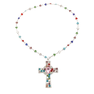 Detailed macro view of silver cross pendant with colorful rhinestones and heart bead chain