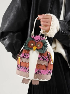 Chic ethnic owl handbag featuring colorful patchwork and decorative metal rivets