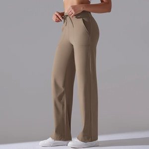 Detail view of khaki drawstring wide-leg yoga pants with side pockets and elastic waistband
