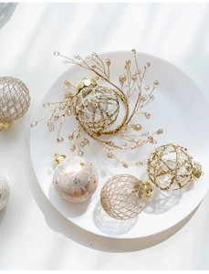 Detail of white and gold Christmas ornaments set with glitter and beaded textures