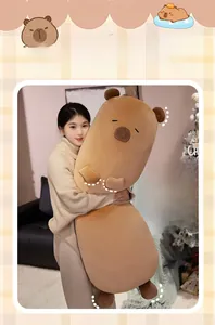 Long capybara plush body pillow being held in a cozy home setting for sleeping comfort