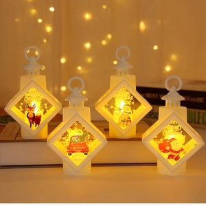 Detail view of four white LED Christmas lanterns featuring festive holiday illustrations