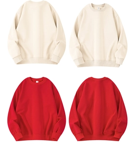 Detail view of cotton crewneck sweatshirts in beige and red with ribbed cuffs