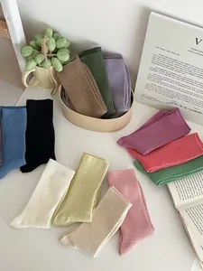 Detailed view of assorted colorful ribbed knit crew socks in various Morandi tones