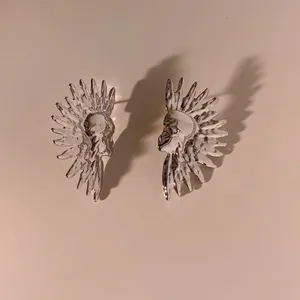 Detailed view of silver stainless steel earrings with native indian feather crown design