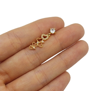 Detail showing the actual size of the gold heart earrings with white cubic zirconia