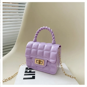 Macro detail of purple lattice jelly bag with golden twist lock and metal chain strap