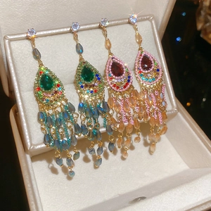 Detail of vintage bohemian drop earrings with colorful crystals in a jewelry box