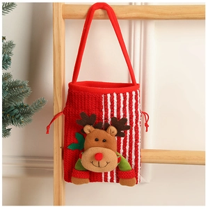 Close-up of 3D reindeer Christmas gift bag made of knitted fabric on wooden ladder
