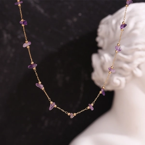 Close-up of 18K gold plated stainless steel necklace with purple amethyst stone beads