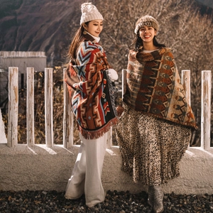 Close-up of bohemian style outdoor blankets with geometric patterns and tassels
