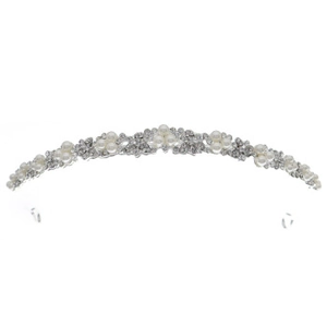 Detail view of silver bridal crown featuring white pearls and sparkling crystals