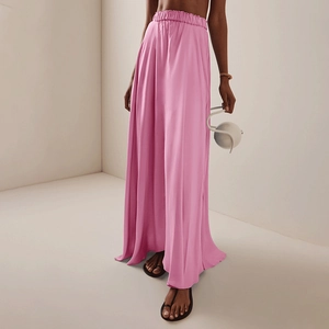 Detailed view of high-waisted pink satin skirt with elegant pleats and draped silhouette