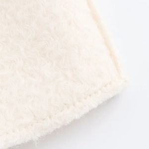 Detailed view of soft white wool texture and precise stitching on the elegant long coat