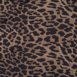 Close-up of leopard print fabric texture with detailed brown and black animal pattern