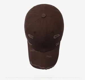 Top down view of a distressed dark brown cotton canvas baseball cap with vintage worn details