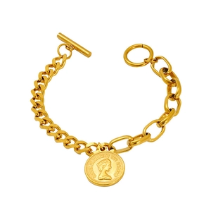 Detailed macro view of vintage gold coin pendant bracelet with Queen portrait and toggle clasp