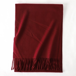 Detailed view of the soft cashmere-feel dark red scarf with elegant fringe texture