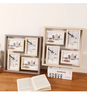 Detail of multi-frame wooden photo display with 4x6 inch minimalist art prints on desk