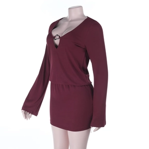 Detail of deep V-neckline with silver metal ring on burgundy long sleeve mini dress