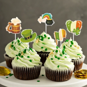 Macro detail of St. Patrick's Day toppers on green frosted cupcakes with gold shamrocks