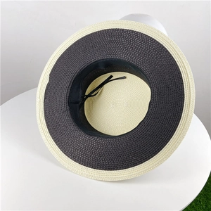 Detail of two-tone woven straw hat interior with adjustable sweatband and texture