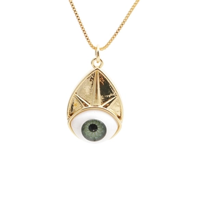 Detailed close-up of golden teardrop evil eye pendant on a delicate gold chain necklace