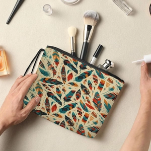Cosmetic bag with colorful feather pattern, zip closure and handy wrist strap
