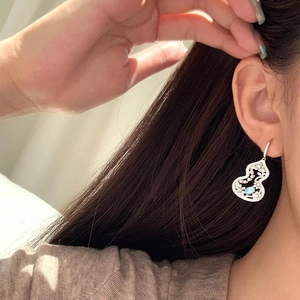 Silver hollow gourd floral earrings with blue gemstones and sparkling zircon accents