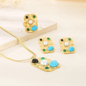 Detailed view of vintage gold jewelry set featuring turquoise gems and pearls