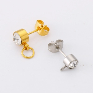 Détail de boucles d'oreilles plaquées or et argent avec zircons et anneaux en acier