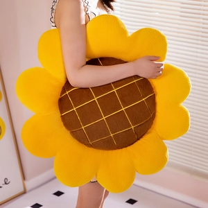 Nordic sunflower plush cushion being held to show its large size and soft texture