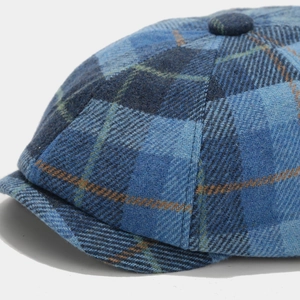 Close-up of blue plaid wool newsboy cap showing detailed textile texture and stitching