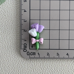 Macro d'un bouquet de fleurs en résine de 2 cm avec nœud rose pour loisirs créatifs DIY