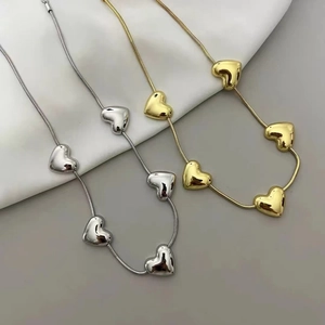Minimalist heart charm snake chain necklace in polished gold and silver finishes