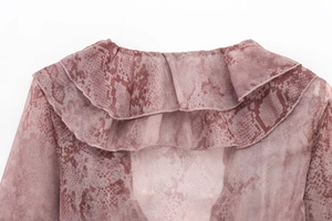 Detail of pink snake print chiffon shirt featuring layered ruffle collar and fine stitching
