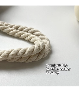 Macro shot of durable twisted cotton rope handles on a beige linen tote bag