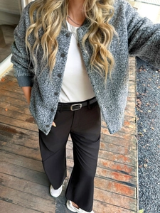 Close-up of grey woolen button jacket with black belt and straight-leg trousers