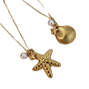 Gold ocean necklaces with starfish shell pendants and pearls on fine chain links