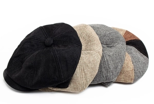 Macro shot of breathable linen texture and button detail on newsboy caps in various colors