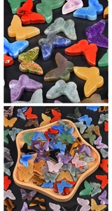 Detailed view of assorted crystal butterfly carvings in a star-shaped wooden bowl