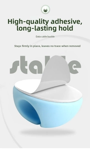 Detailed view of light blue silicone cable clip with strong adhesive backing for desk
