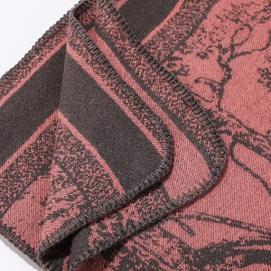 Close-up of pink and grey forest deer pattern fabric with premium lockstitch edges