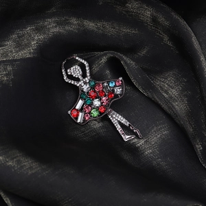 Detailed view of ballet dancer brooch with vibrant multicolor rhinestones on black silk