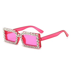 Trendy rectangular rhinestone sunglasses in hot pink for stylish women street photography
